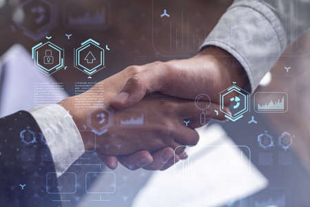 Handshake of two businesspeople as agreement concept to develop a new software to improve service at a company. Technological icons. Woman in business.の写真素材