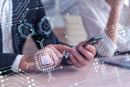 Two research and development specialists brainstorming on project to create a new approach to develop software to improve business . Working with phone. Tech hologram icons. Formal wear.の写真素材