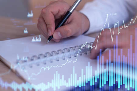A trader in formal wear writing down some ideas to research stock market to proceed right investment...