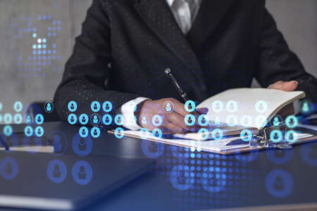 Woman HR specialist is taking notes concerning new candidates to create international network in...