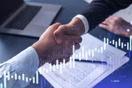 A handshake symbolize a capital market transaction to proceed profitable business in stock trading....