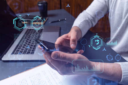 Programmer holding in the hands a smart phone and testing an innovative application to provide a...