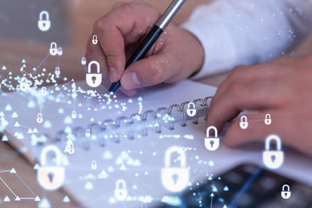 A programmer is taking notes of clients needs to protect cyber security from hacker attacks and save...