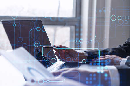 Two information technology specialist brainstorming on project to create a new approach to develop software to improve business service. Working with laptop. Tech hologram icons.の写真素材