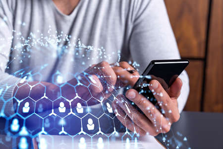 Hands of hr specialist browsing social networks in the Internet in smart phone to find the best...