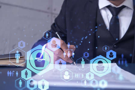 A potential employee in formal suit signing the contract to boost his career and gain new...