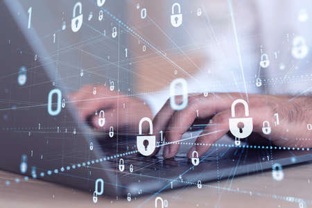 A programmer is typing a code on computer to protect a cyber security from hacker attacks and save...