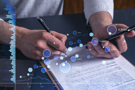A client in casual wear is signing the contract to invest money in stock market. Internet trading...