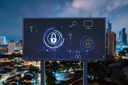 Padlock icon hologram on road billboard over panorama city view of Kuala Lumpur at night to protect...