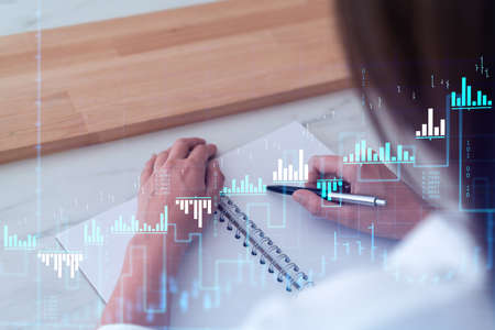 A woman trader in formal wear writing down some ideas to research stock market to proceed right...