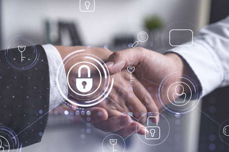 Handshake of two businesspeople who are negotiated the project to protect cyber security of...