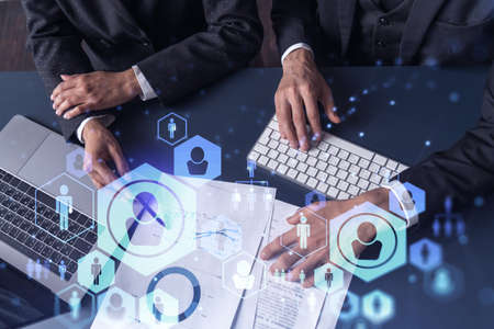 Two HR specialists man and woman analyzing the market of alumni to boost the intern program at...