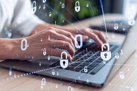 A woman programmer is typing a code on computer to protect a cyber security from hacker attacks and...