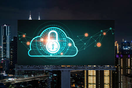 Padlock icon hologram on road billboard over panorama city view of Kuala Lumpur at night to protect business, Malaysia, Asia. The concept of information security shields.の写真素材