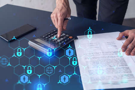 A businessman computing probability of risks in cyber security protection using calculator. Padlock...