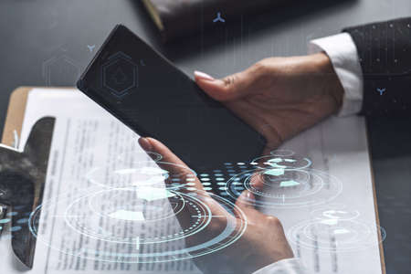 Businesswoman in formal wear checking the phone to sign the contract to create a software to present...