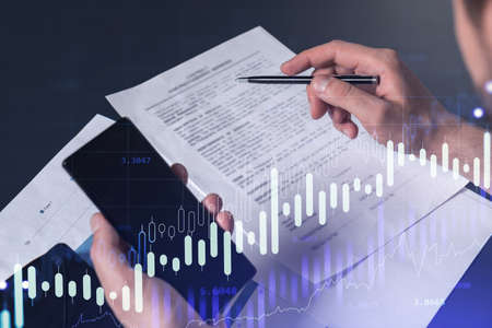 A client in casual wear is signing the contract to invest money in stock market. Internet trading...