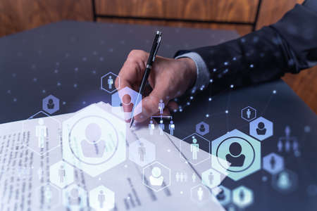 A potential employee in formal suit signing the contract to boost his career and gain new...