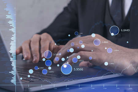 Hands typing the keyboard to research stock market to proceed right investment solutions. Internet...