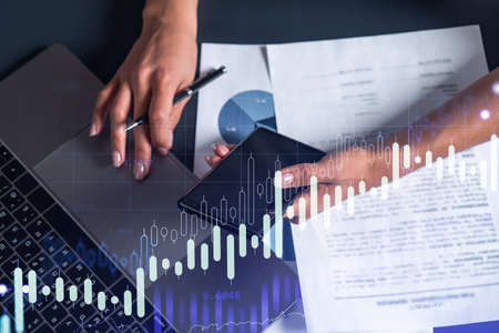 Woman hands typing the keyboard to research stock market to proceed right investment solutions....
