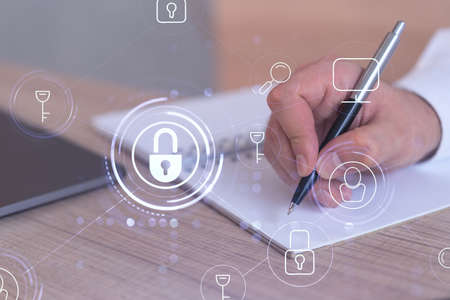 A programmer is taking notes of clients needs to protect cyber security from hacker attacks and save...