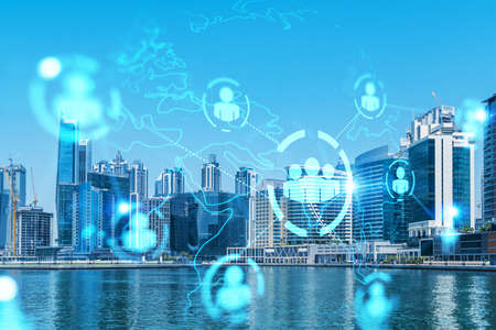 Skyscrapers of Dubai business downtown. International hub of trading and financial services. Social network icons hologram, concept of people connection. Double exposure. Dubai Canal waterfront.の写真素材