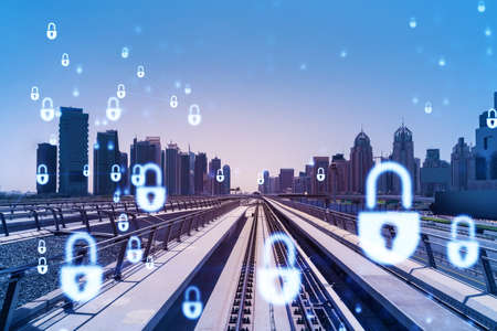 The way towards skyscrapers by modern futuristic train. Tech railway delivers commuters to the financial downtown of Dubai. Information protection concept. Padlock drawings. Double exposureの写真素材