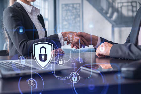 Handshake of two businesspeople who are negotiated the project to protect cyber security of...