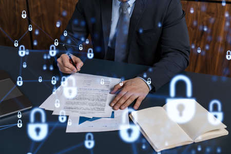 A businessman in formal wear signing the contract to prevent probability of risks in cyber security....