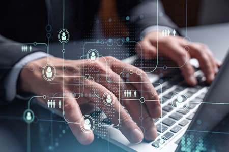 Hands of hr specialist is typing the keyboard in the internet to find the best candidates to create...