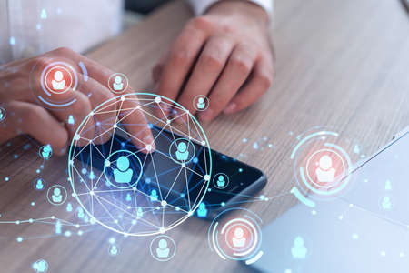 Hands of hr specialist browsing social networks in the Internet in smart phone to find the best...