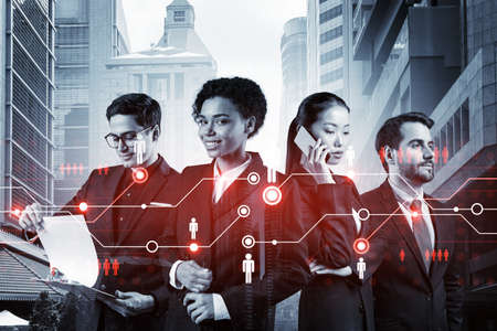 Group of SMM specialists working on social media marketing strategy to achieve business goals. Hologram icons over Singapore background.の写真素材