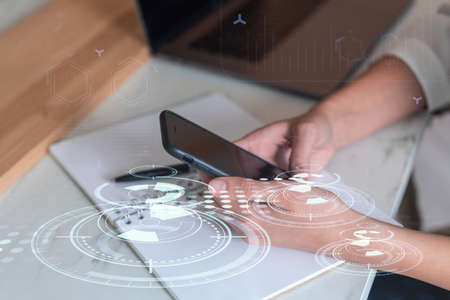 Businesswoman in formal wear holding in the hands a smart phone and testing an innovative...