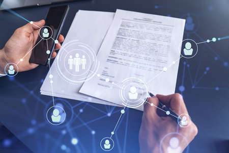 A potential employee in formal suit signing the contract to boost his career and gain new...