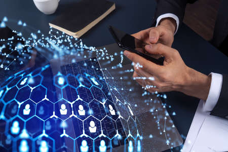 Hands of hr specialist browsing social networks in the Internet in smart phone to find the best candidates to hire international team. Concept of success. Media hologram icons. Formal wear.の写真素材