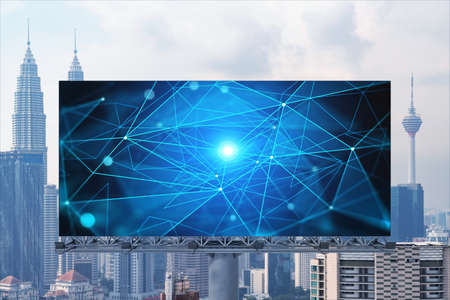 Technology hologram on billboard over panorama city view of Kuala Lumpur. KL is the largest tech hub in Malaysia, Asia. The concept of developing coding and high-tech science.の写真素材
