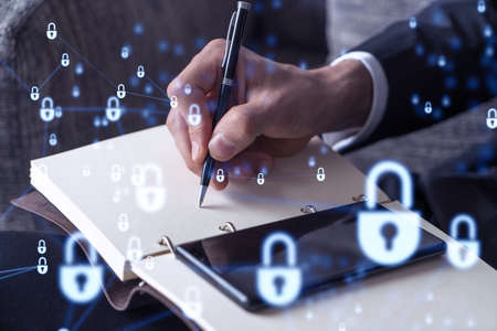 Programmer is taking notes of clients needs to protect cyber security from hacker attacks and save...