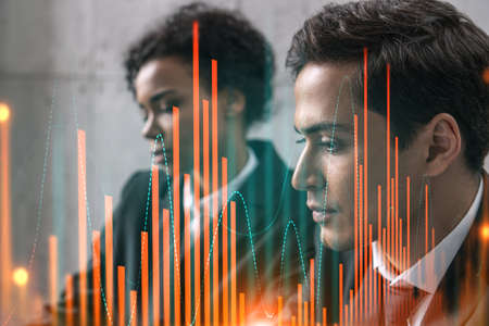 Two businesspeople working on market behavior. Trading concept. Forex graph. hologram.の写真素材