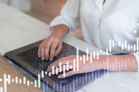 Woman typing the keyboard to research stock market to proceed right investment solutions. Internet...