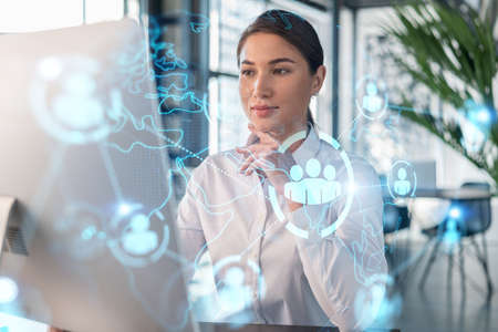 Attractive businesswoman in white shirt at workplace working with laptop to hire new employees for...