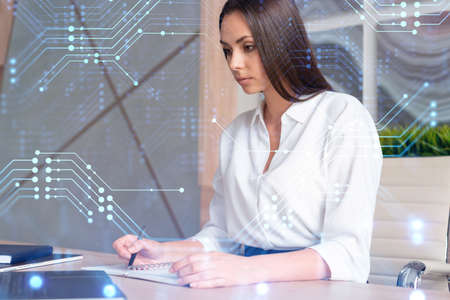 Portrait of attractive businesswoman in formal wear working with documents and thinking how to optimize business process by applying new technologies. Hi tech holograms over modern office backgroundの写真素材