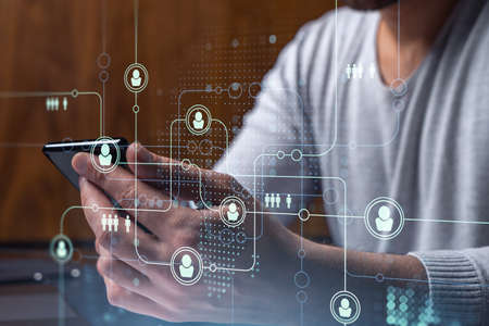 Hands of hr specialist browsing social networks in the Internet in smart phone to find the best...