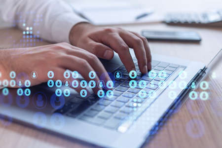 Hands of hr specialist is typing the keyboard in the internet to find the best candidates to create...