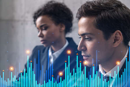 Two businesspeople working on market behavior. Trading concept. Financial graph hologram. Multiexposure.の写真素材