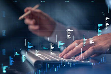 Hands typing the keyboard to research stock market to proceed right investment solutions. Internet...