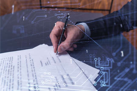 A client in dark blue suit is signing a contract to create a new software to present it in start up...