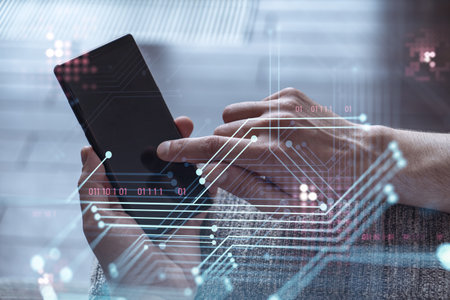 Programmer holding in the hands a smart phone and testing an innovative application to provide a...