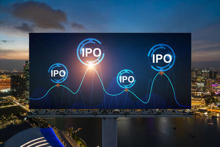 IPO icon hologram on road billboard over night panorama city view of Singapore. The hub of initial...
