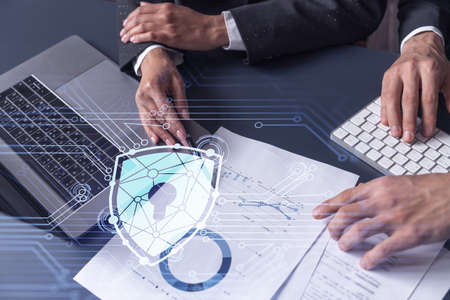 Two businesspeople man and woman working on the project to protect cyber security of international...