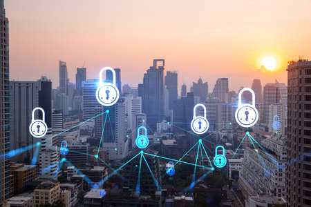 Hologram of Padlock on sunset panoramic cityscape of Bangkok, Asia. The concept of cyber security...